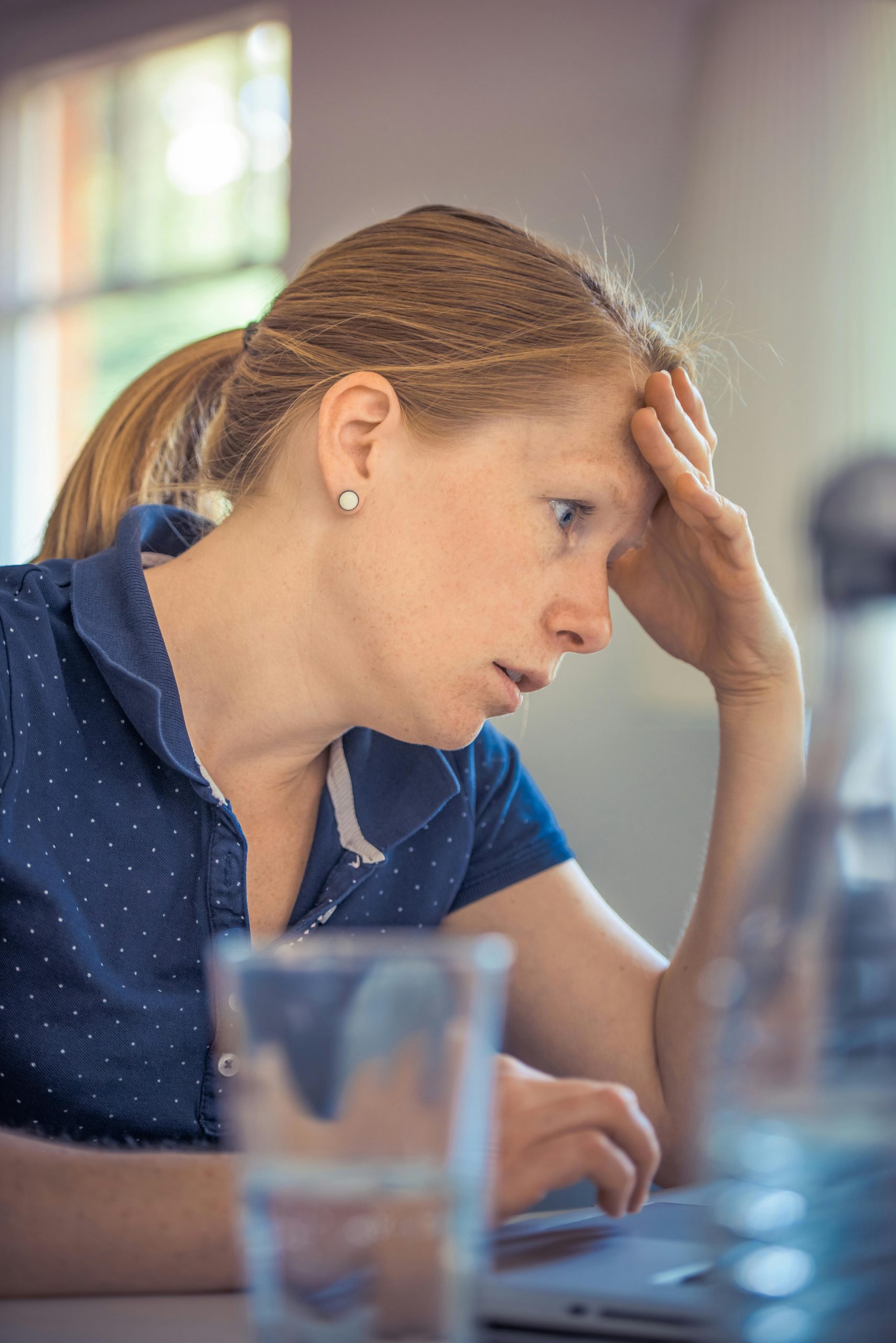 Businesswoman showing stress and concentration while working at her desk.